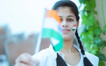 teenager girl holding flag outdoor shoot. location Delhi.